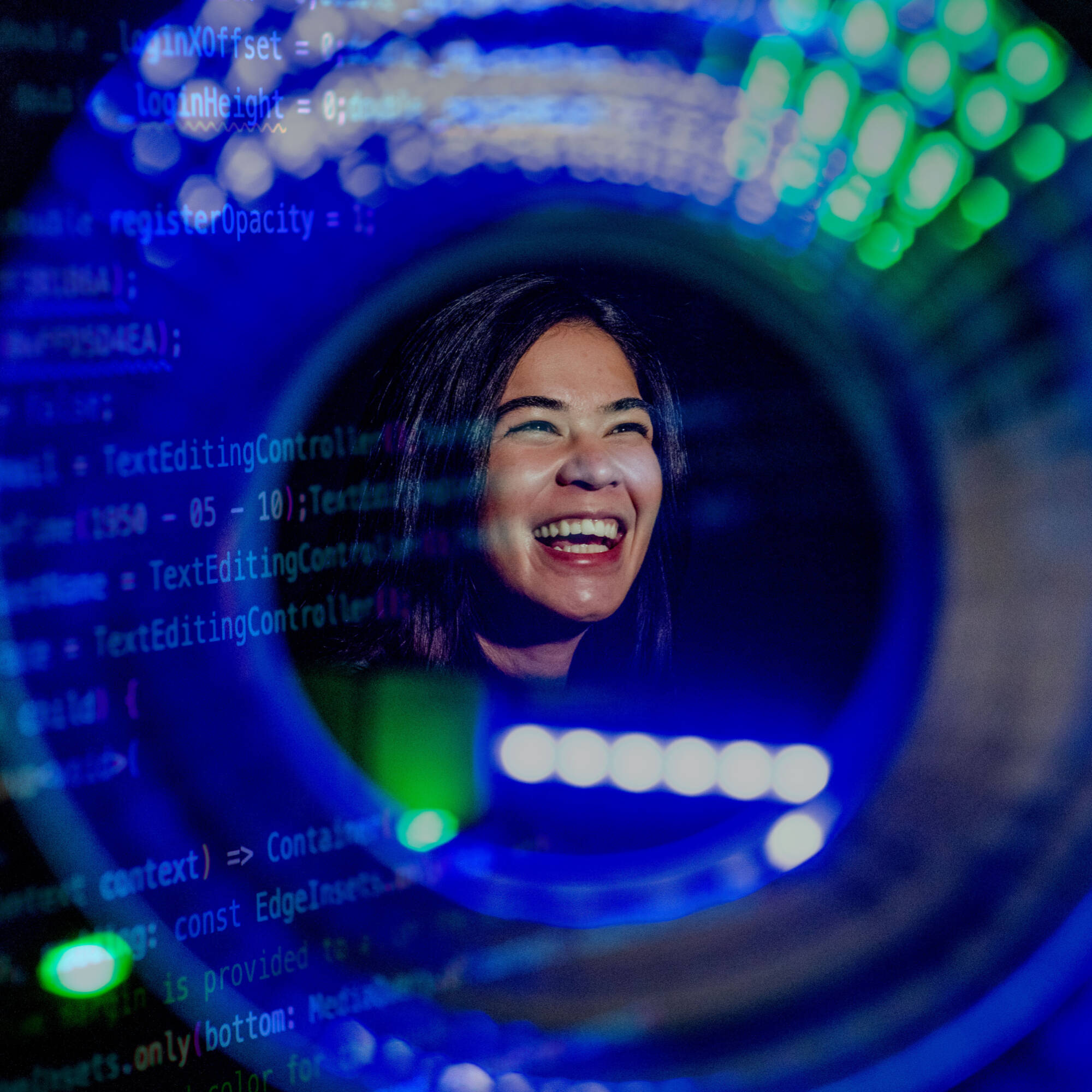GVSU computing student looking at a brightly colored screens.